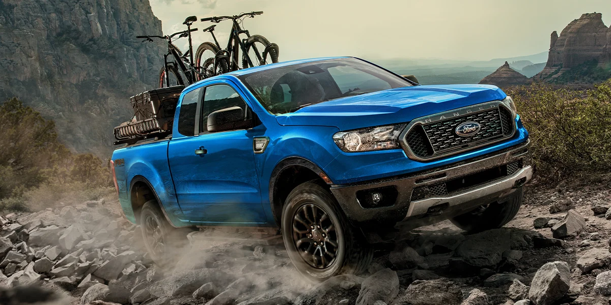 The 2023 Ford Ranger with bicycles in the bed climbing a mountain